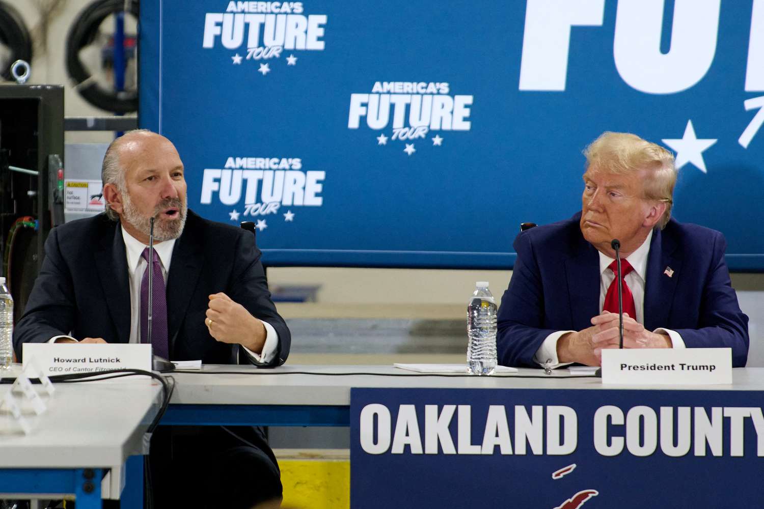 Former president Donald Trump, right, participates in a round table with Howard Lutnick, left, in Auburn Hills, MI, Friday, Oct. 18, 2024. 