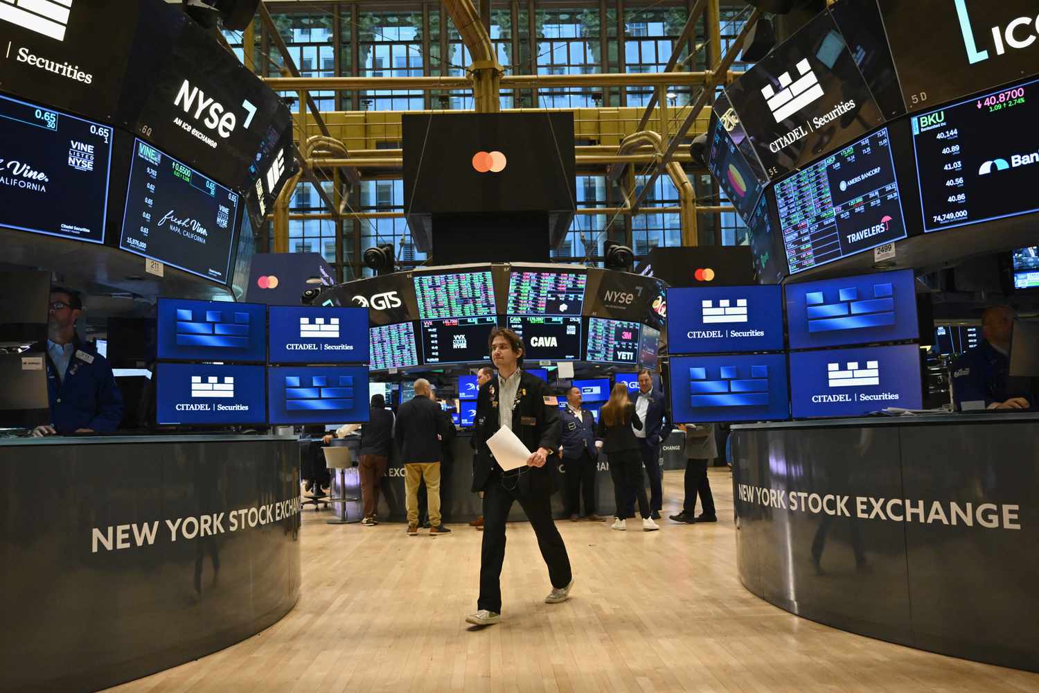 Traders work on the floor of the New York Stock Exchange (NYSE) at the opening bell on November 13, 2024