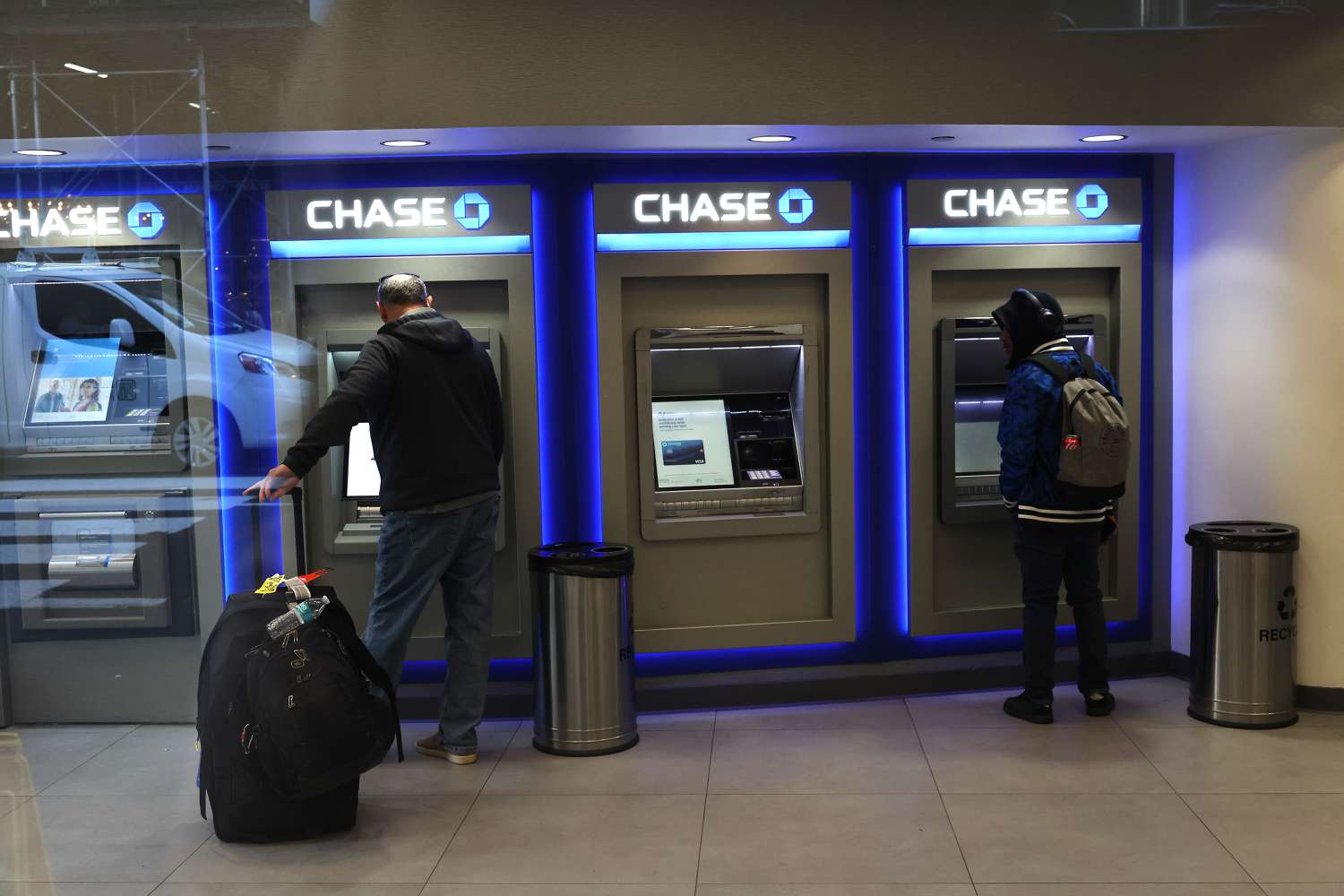 People use ATMs at a Chase Bank on October 11, 2024 in New York City.