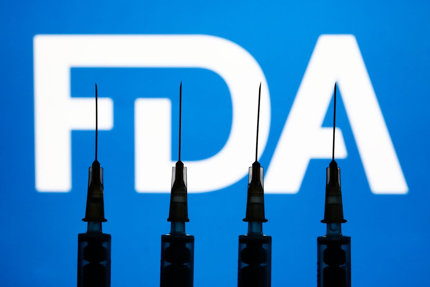 Medical syringes and FDA logo displayed in the background