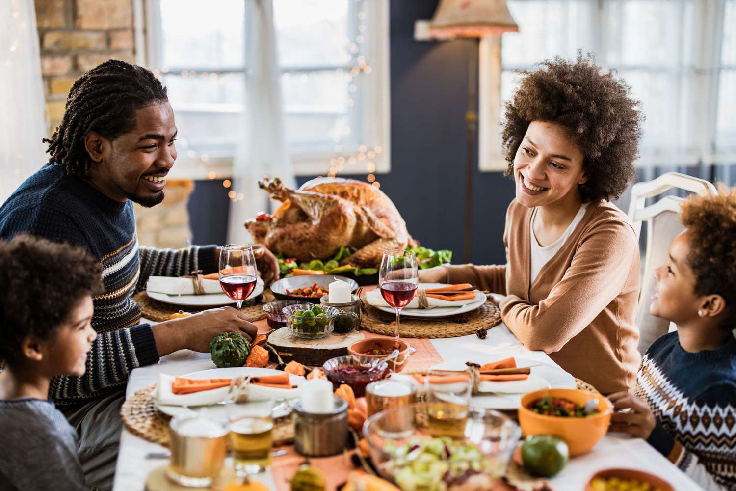 Family enjoying a Thanksgiving meal at a dining table