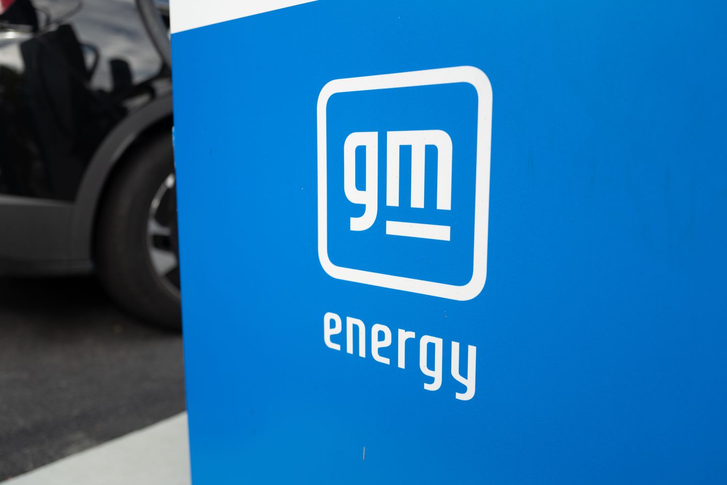 A blue electric vehicle charger with the logo GM Energy