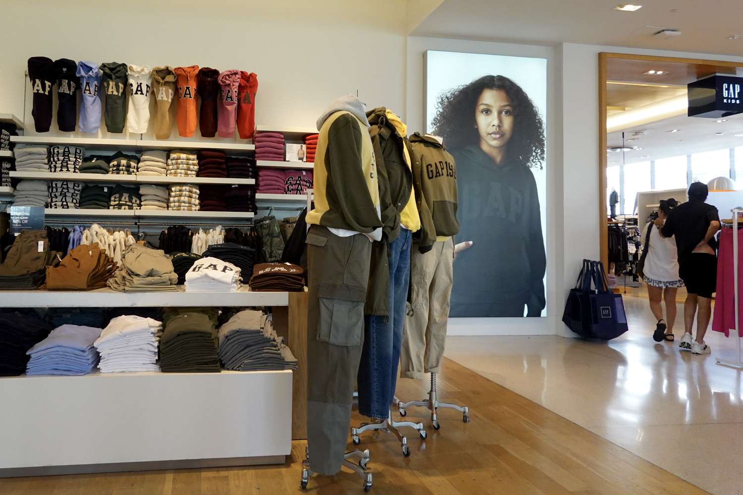 Shoppers walk in a Gap store on November 21, 2024 in Miami Beach, Florida