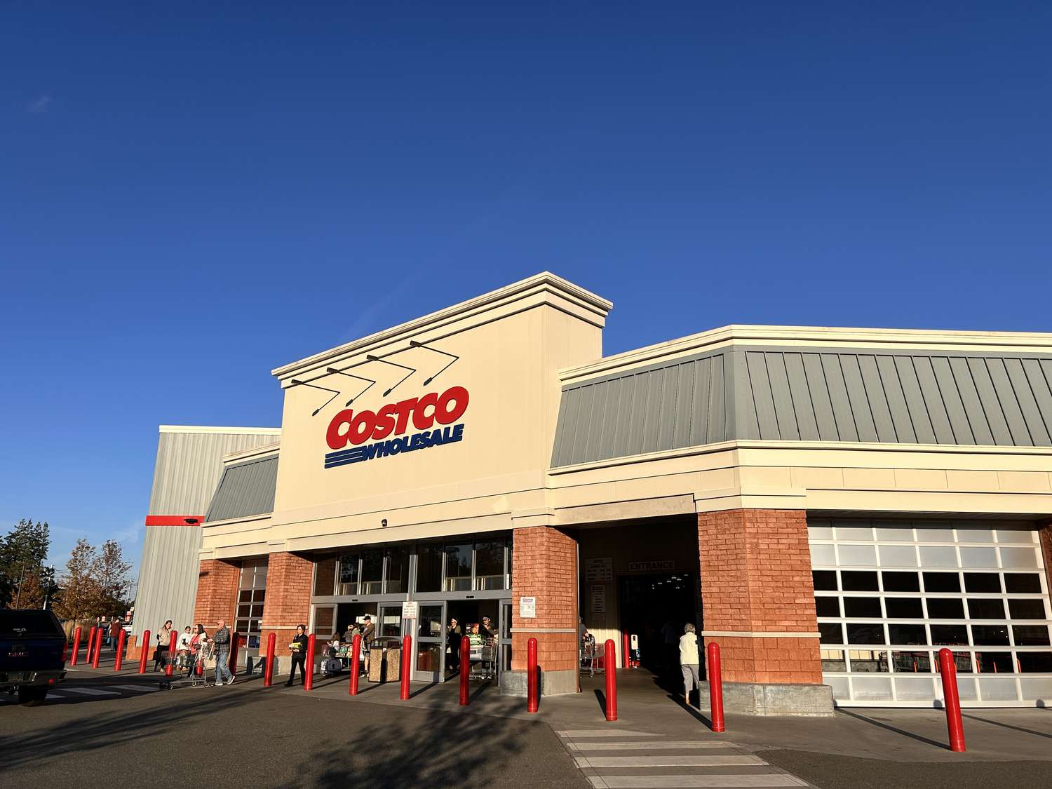 A Costco Wholesale store is seen in front of a blue sky.