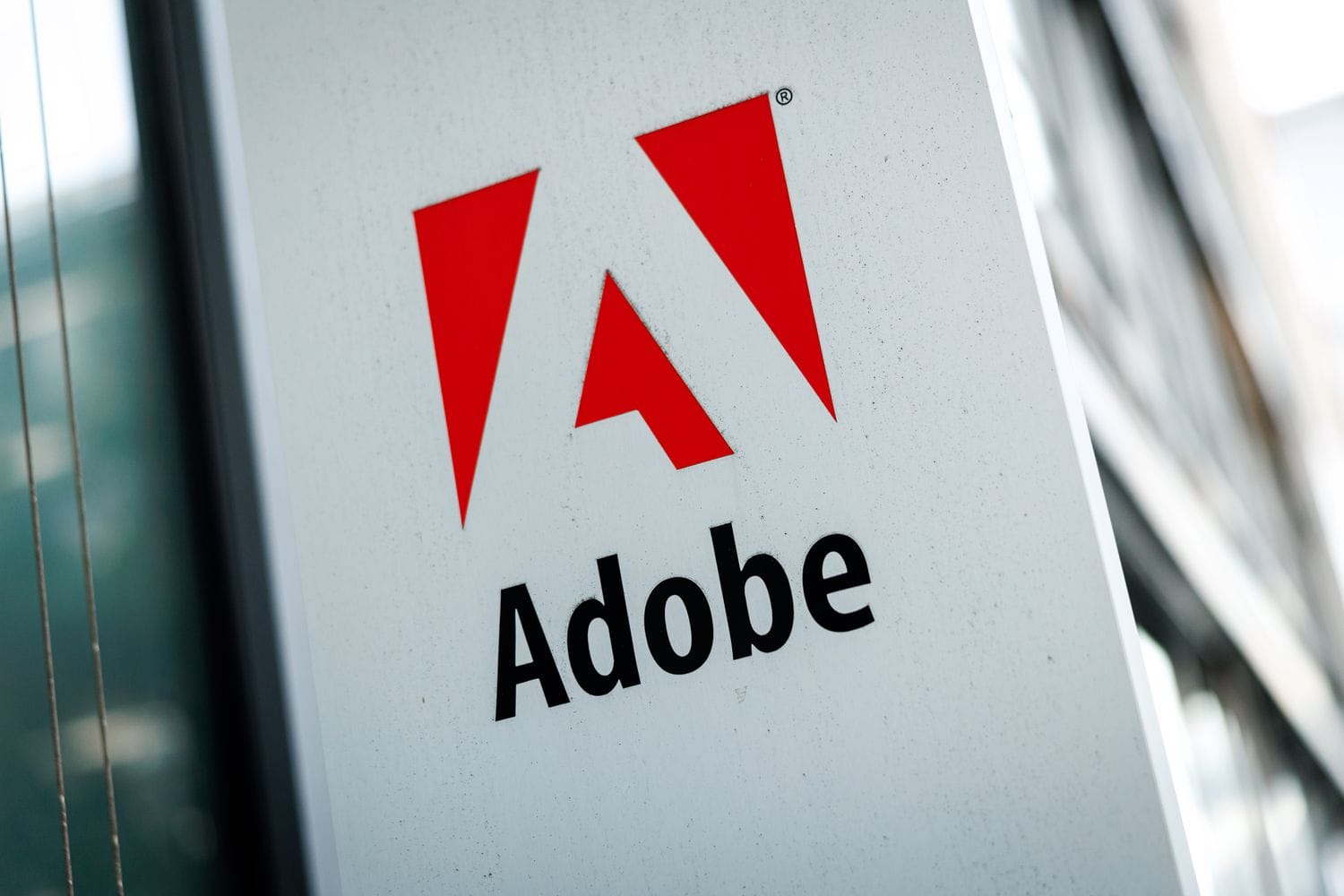 The red "A" Adobe logo on a white sign on the side of a building