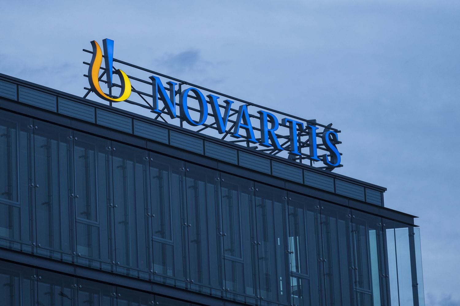 An illuminated Novartis AG logo above an office building in Prague, Czech Republic, on Aug. 26, 2024