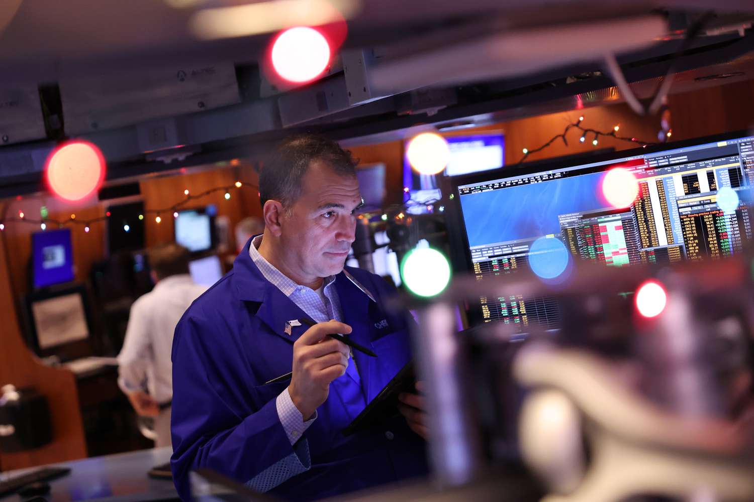 Traders work on the floor of the New York Stock Exchange during morning trading on November 26, 2024