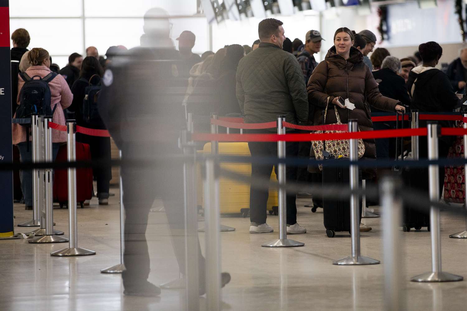 Travelers wait in line at an airport in Michigan on Dec. 1. 