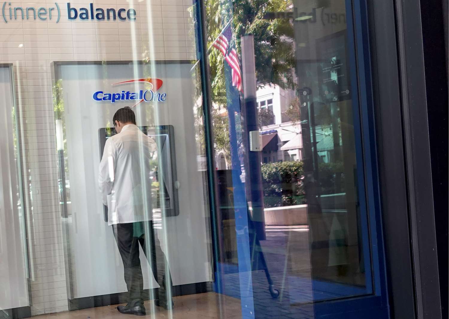 A customer makes a transaction at a Capital One ATM on February 19, 2024, in Miami, Florida. 