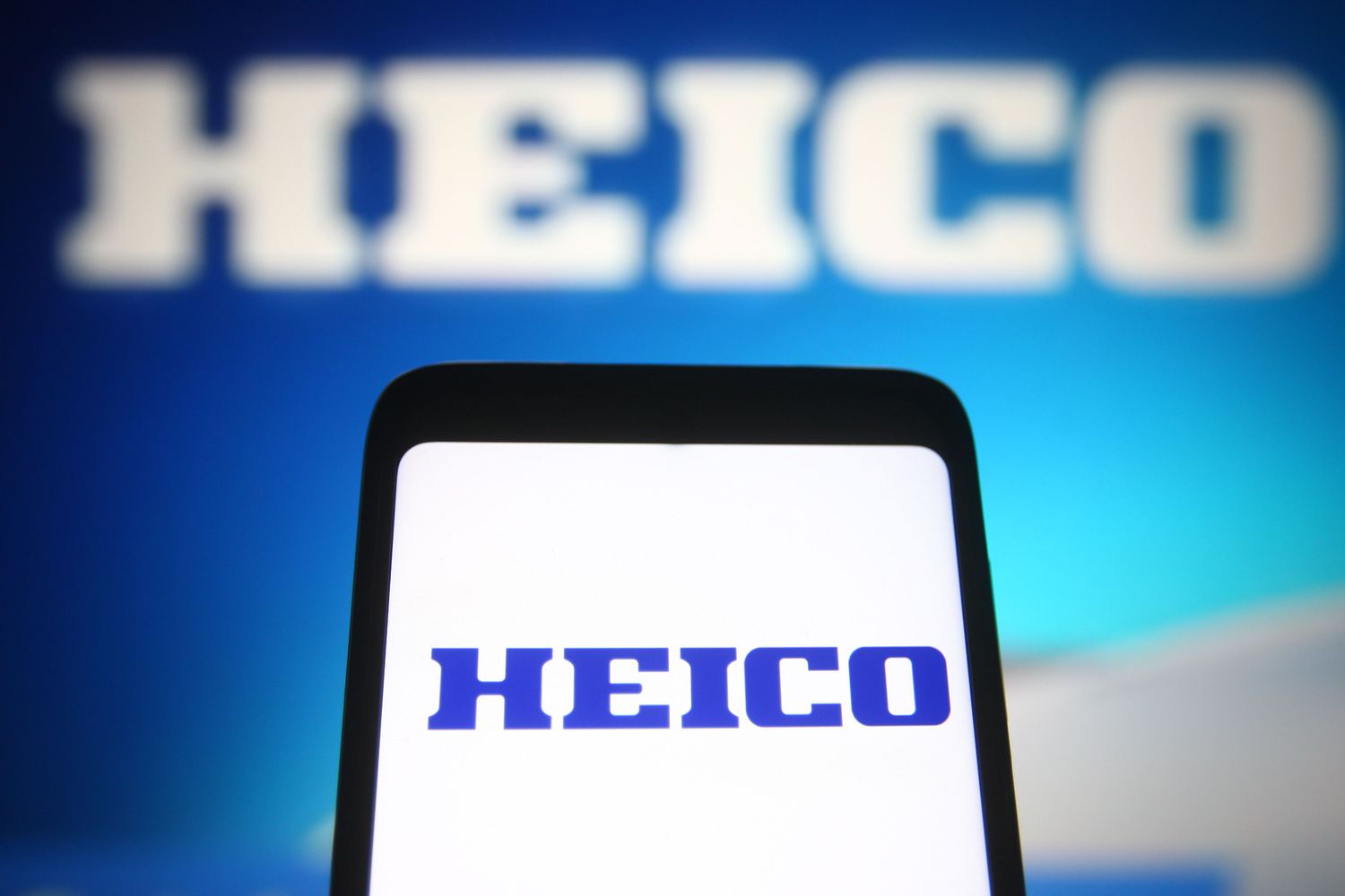 Heico Corp. logo on a smartphone and background screen