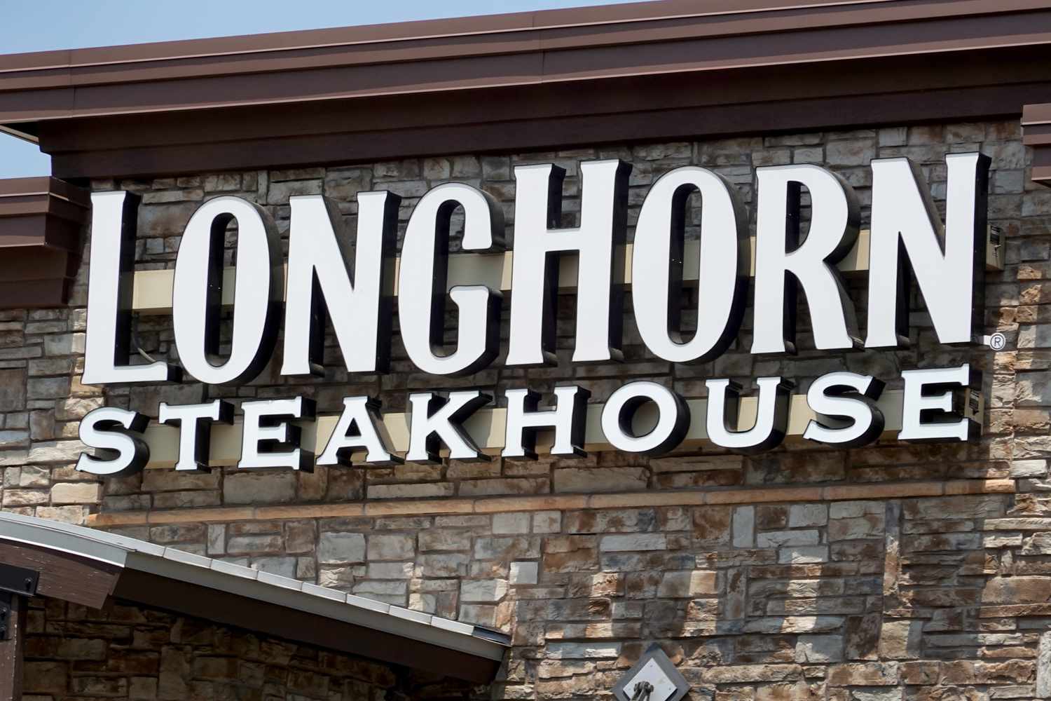 The LongHorn Steakhouse logo is seen on the outside of a building.