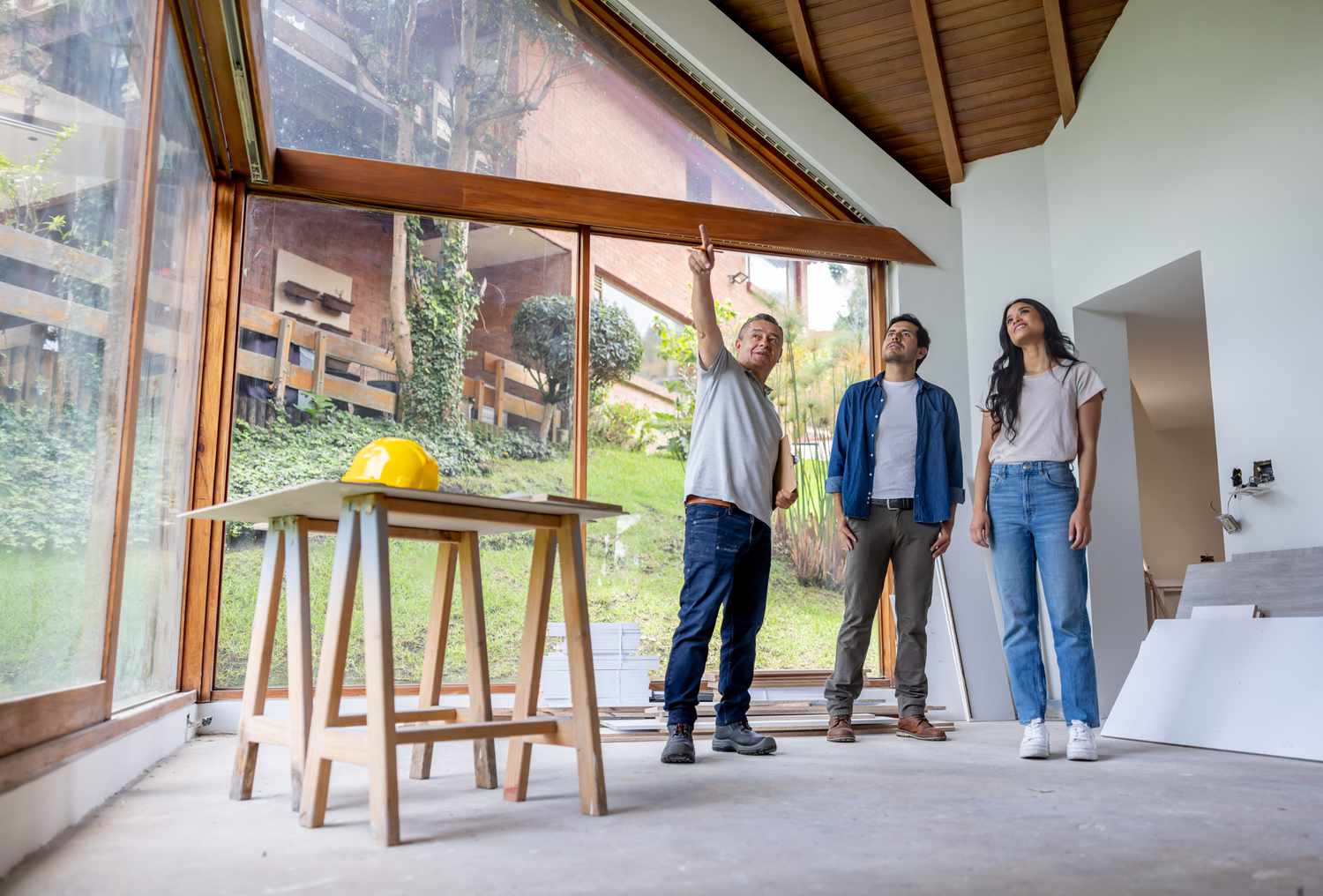 A stock image of a contractor discussing renovations with his clients. 