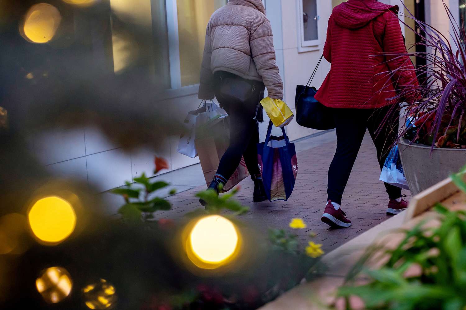 Shoppers carry bags at Broadway Plaza in Walnut Creek, California, US, on Monday, Dec. 16, 2024.