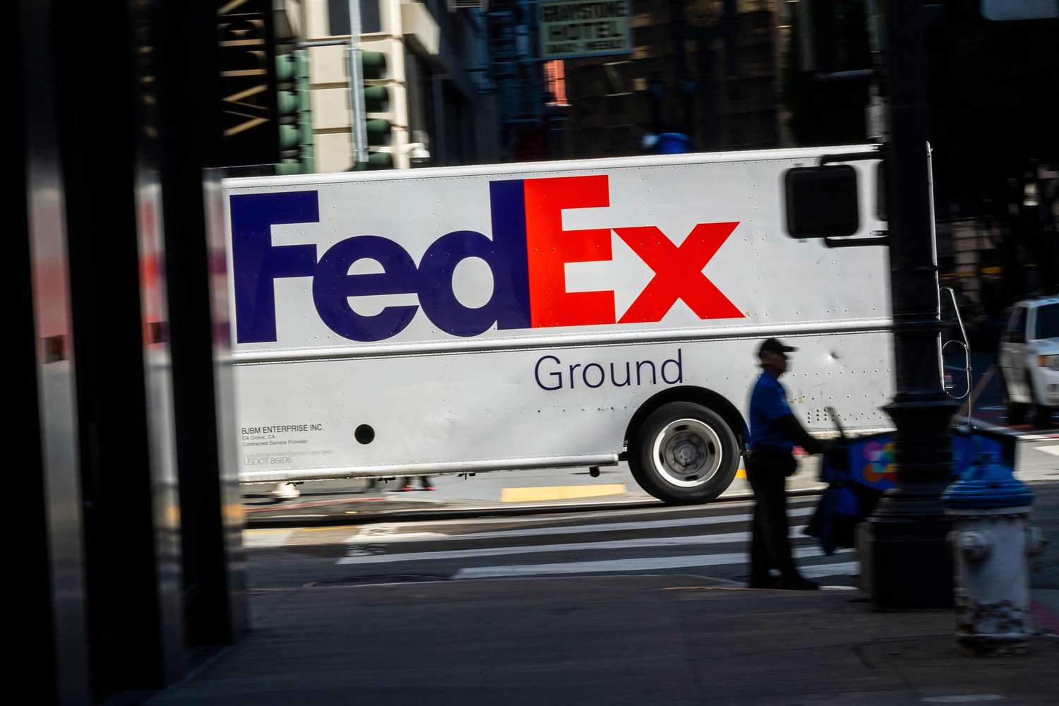 A FedEx truck is seen driving on the street