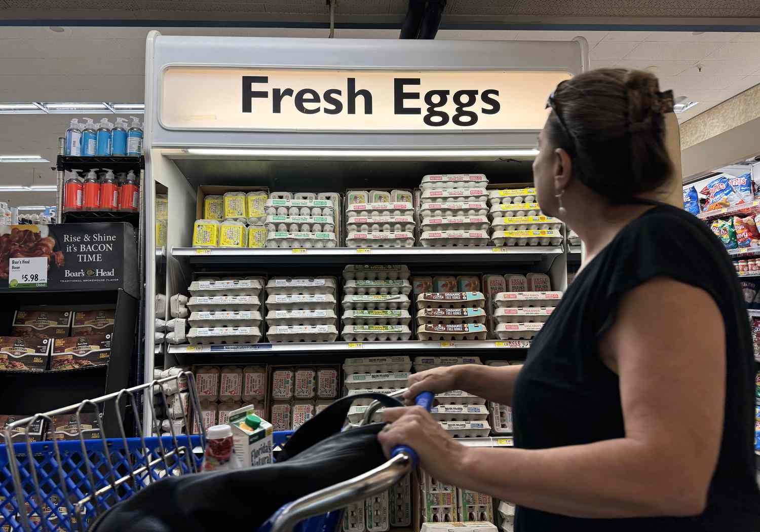 A customer walks by a display of fresh eggs at a grocery store on September 25, 2024 in San Anselmo, California. 