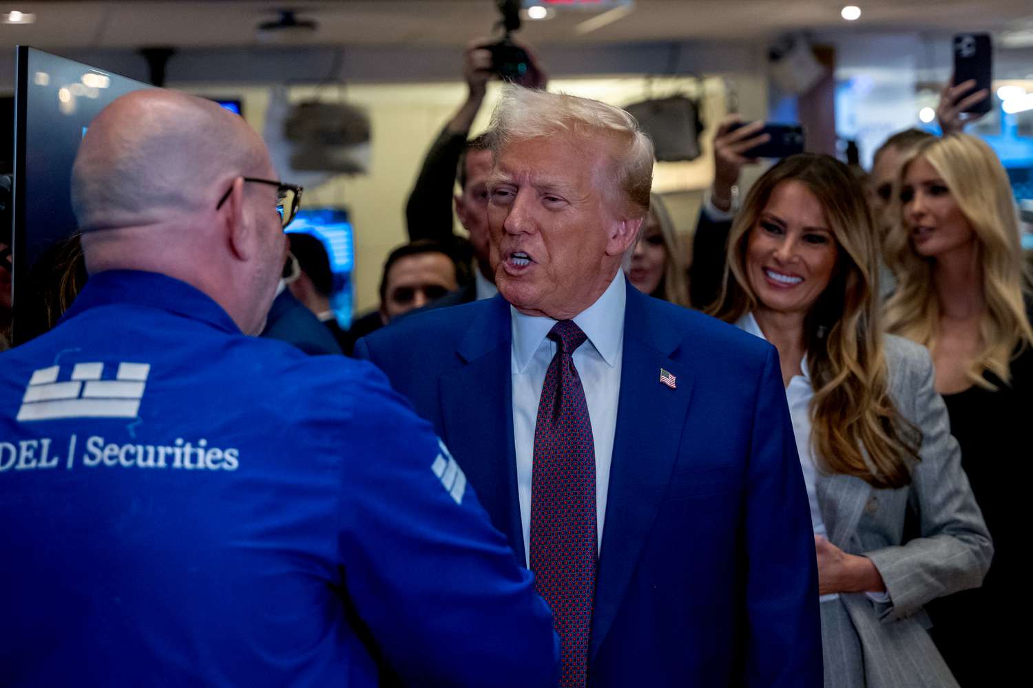 President-elect Donald Trump walks onto the floor of the New York Stock Exchange with his wife Melania, on Dec. 12, 2024.