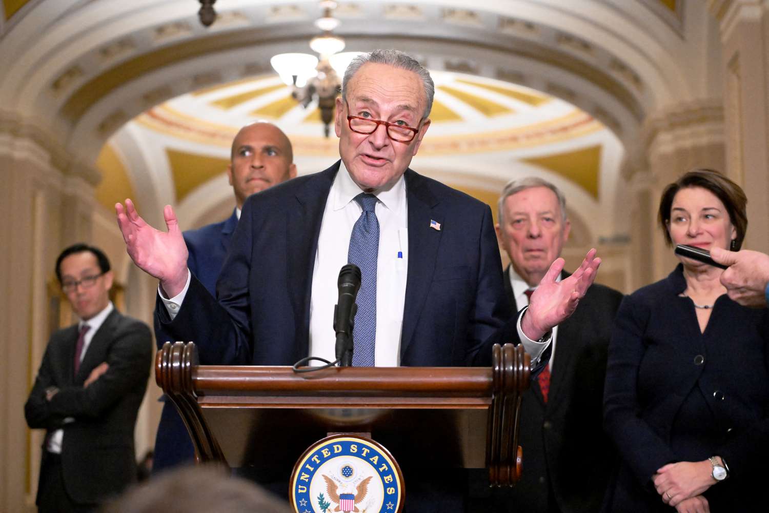 US Senate Majority Leader Chuck Schumer, with Democratic majority whip Dick Durbin (2nd R, Senator Amy Klobuchar (R) and Senator Cory Booker (2nd L), speaks with reporters at the US Capitol on December 3, 2024. 