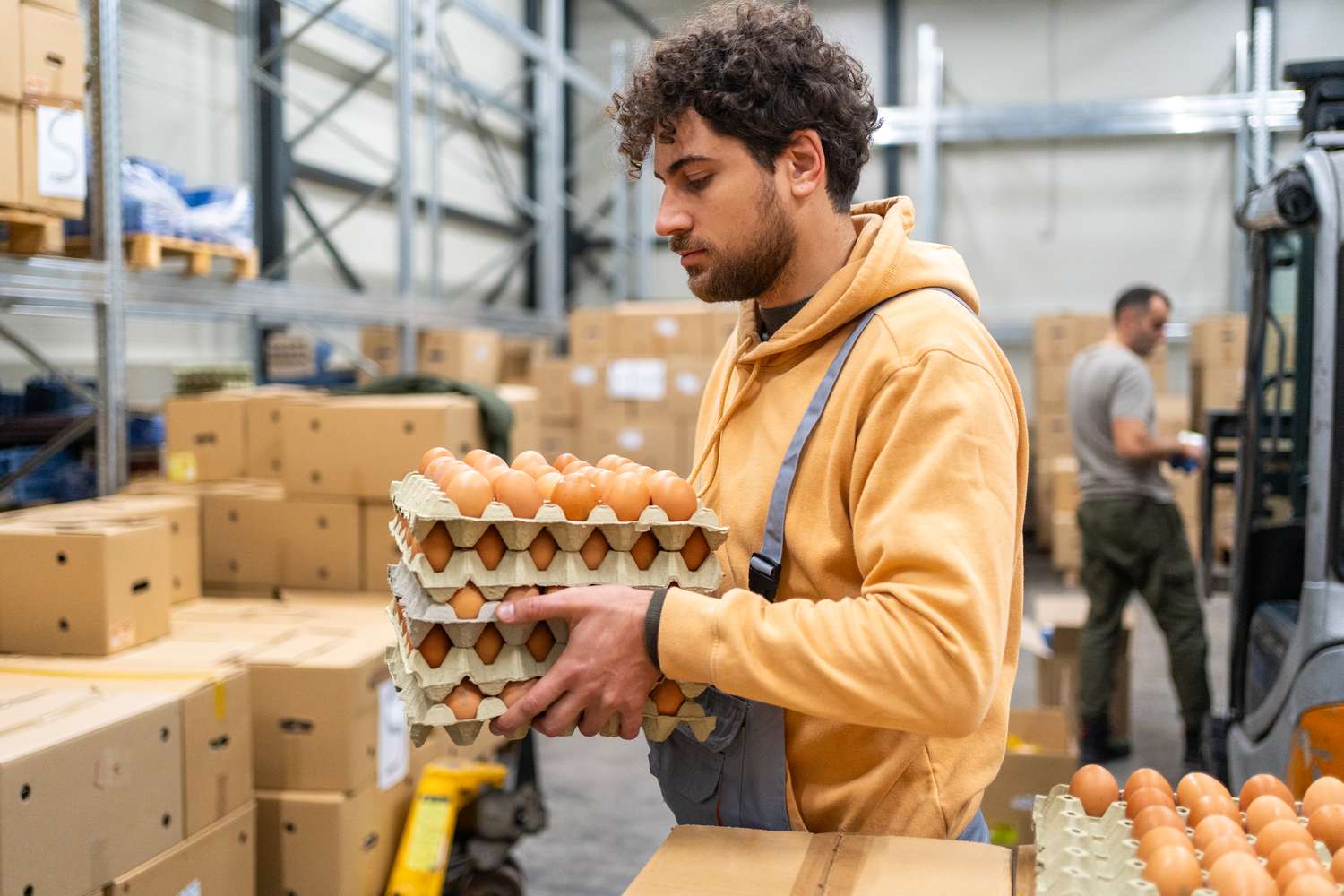 Man carrying eggs at distribution warehouse