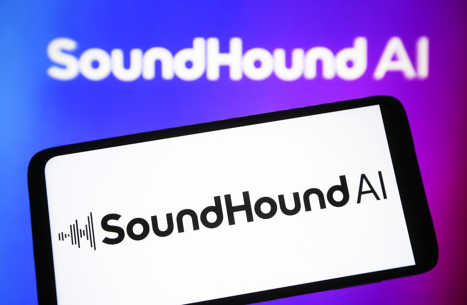 An image of the SoundHound AI logo on a mobile device. 