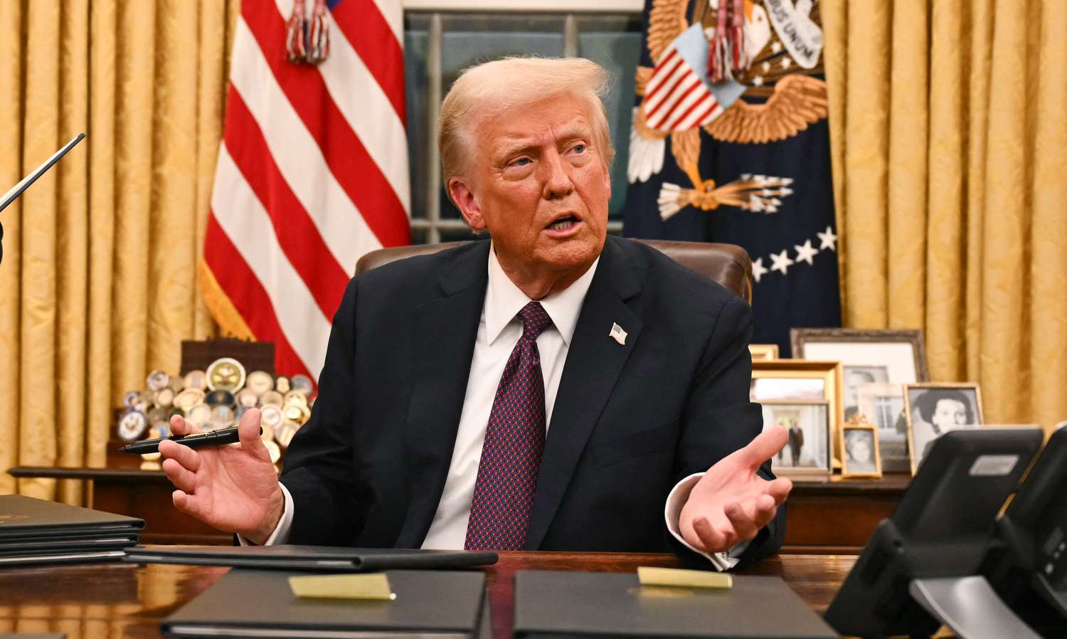 U.S. President Donald Trump speaks to journalists as he signs executive orders in the Oval Office of the White House in Washington, DC, on January 20, 2025.