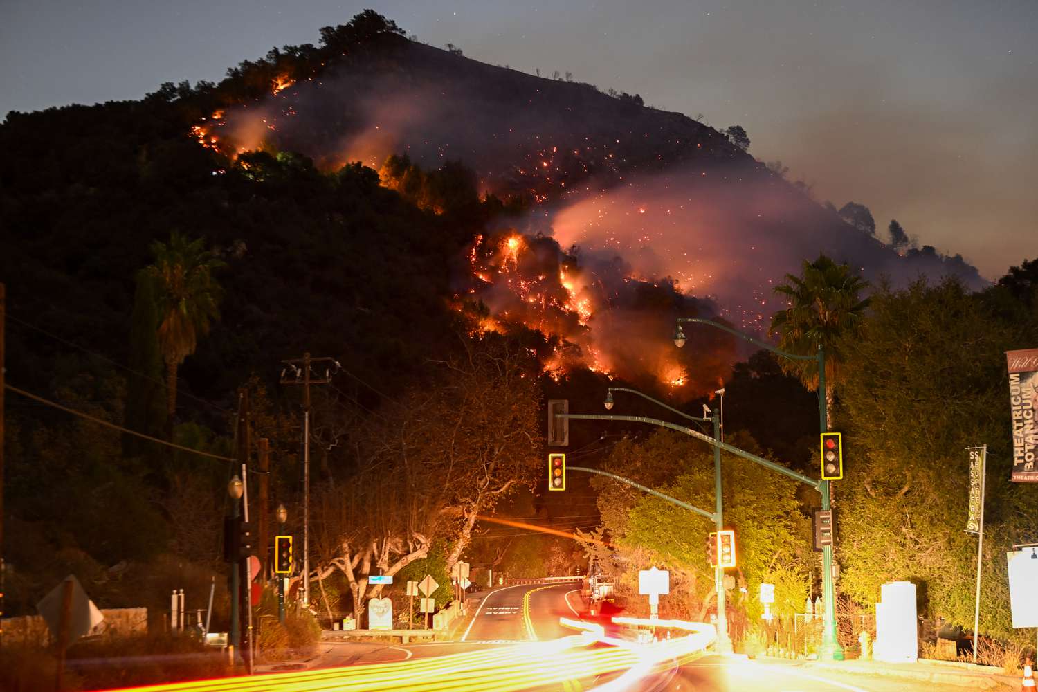  A view of flames at the mountain as seen from Topanga Canyon near Pacific Palisades in Topanga, Los Angeles, Californi