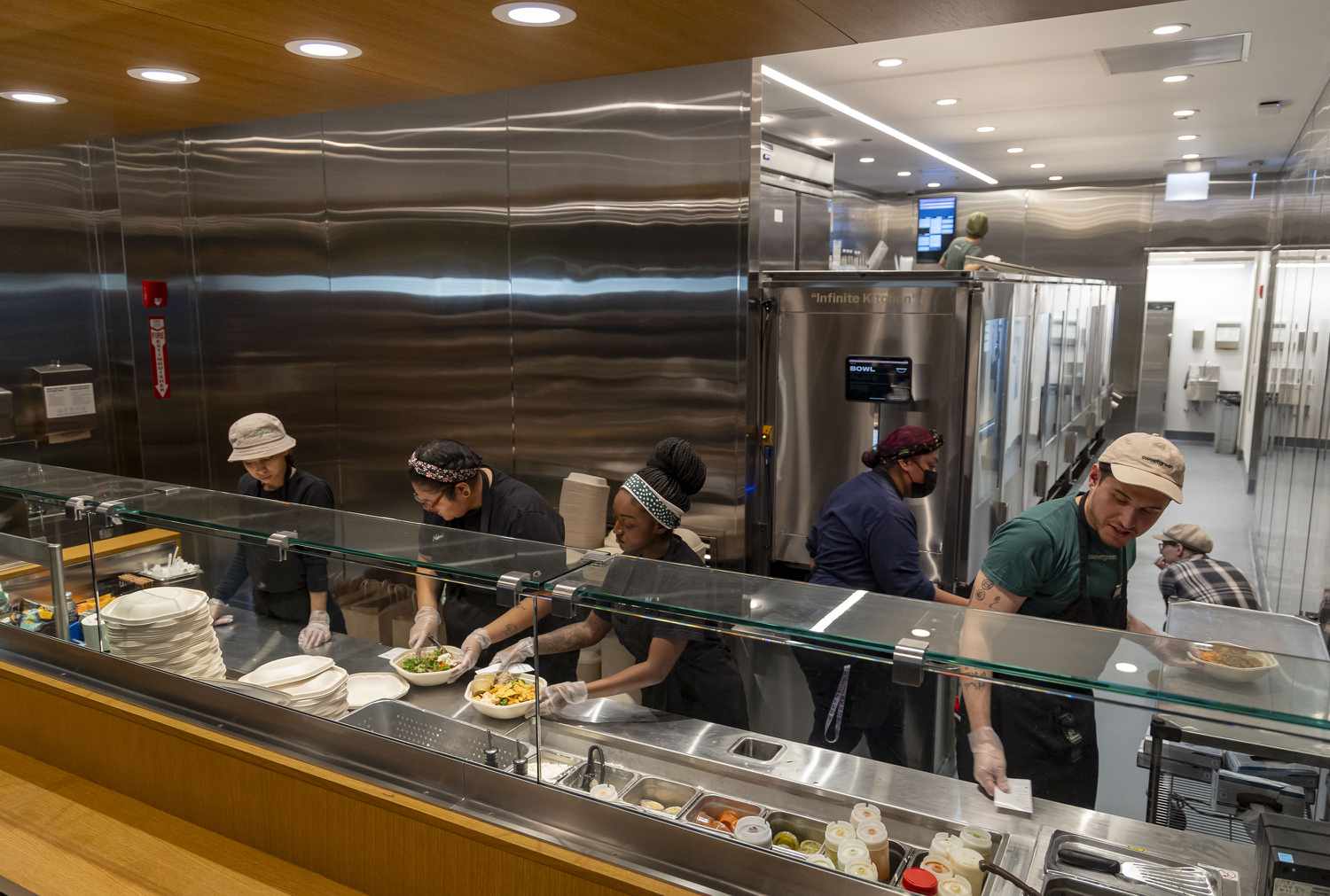 Sweetgreen workers add the final ingredients to salads on Sunday, Dec. 15, 2024, at Willis Tower. 