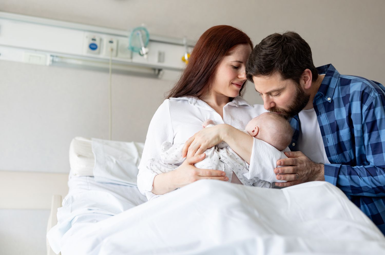 parents with a newborn baby in the hospital