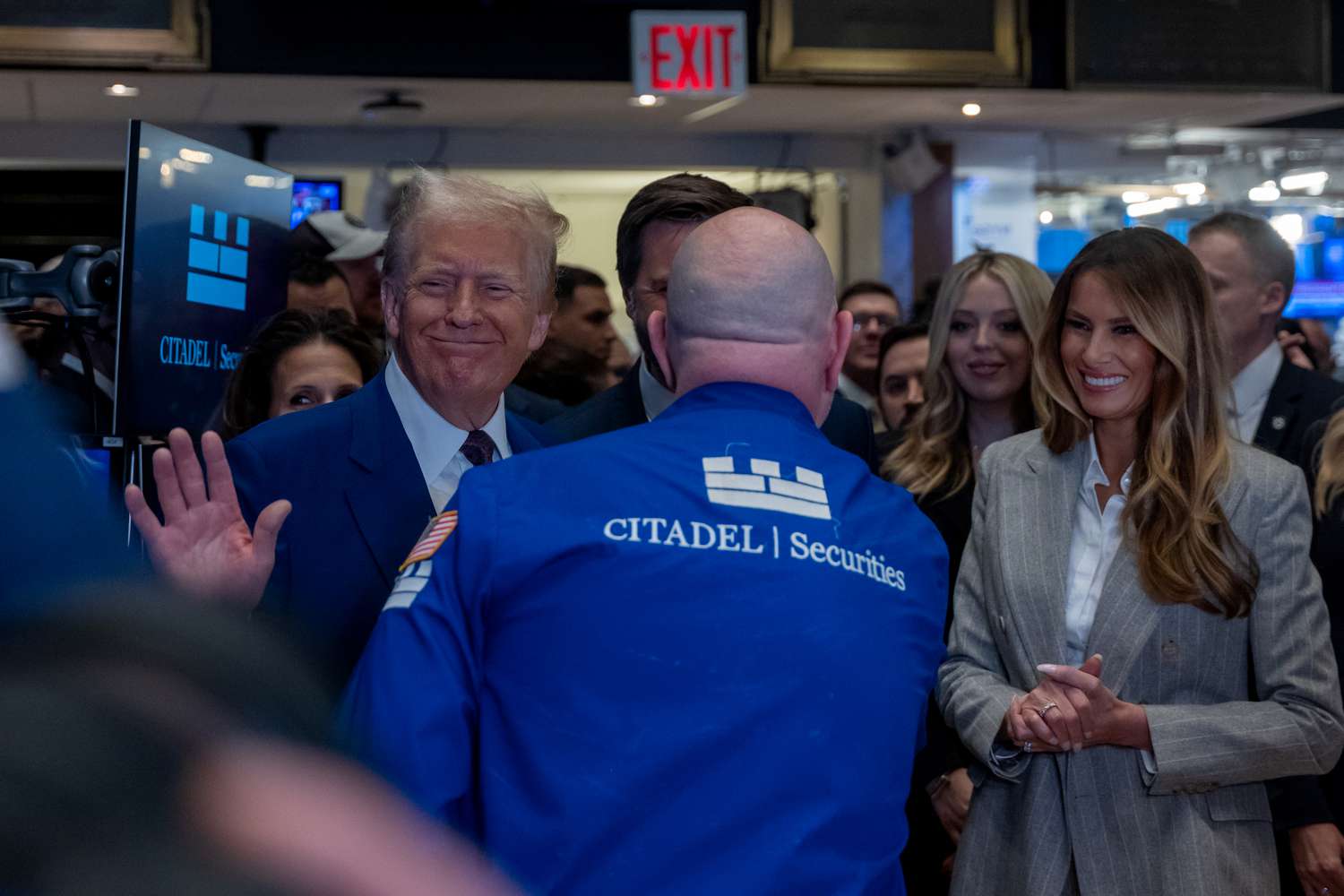 President-elect Donald Trump walks onto the floor of the New York Stock Exchange with his wife Melania on Dec. 12, 2024.