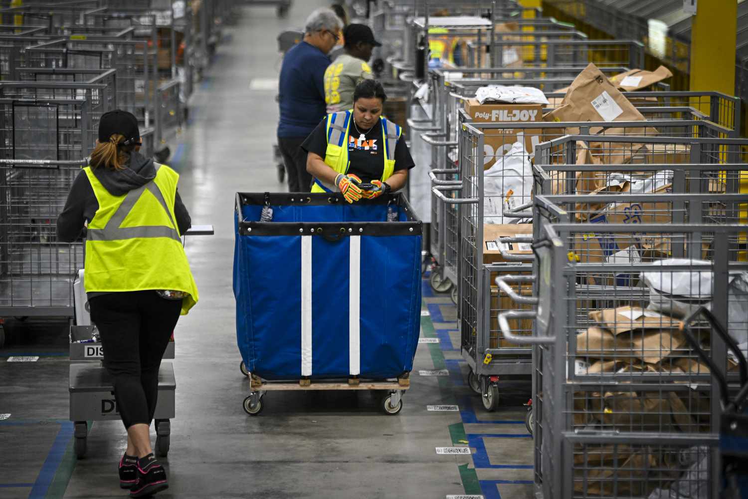 Amazon employees work to fulfill same-day orders during Cyber Monday, one of the company's busiest days at an Amazon fulfillment center on December 2, 2024 in Orlando, Florida. 